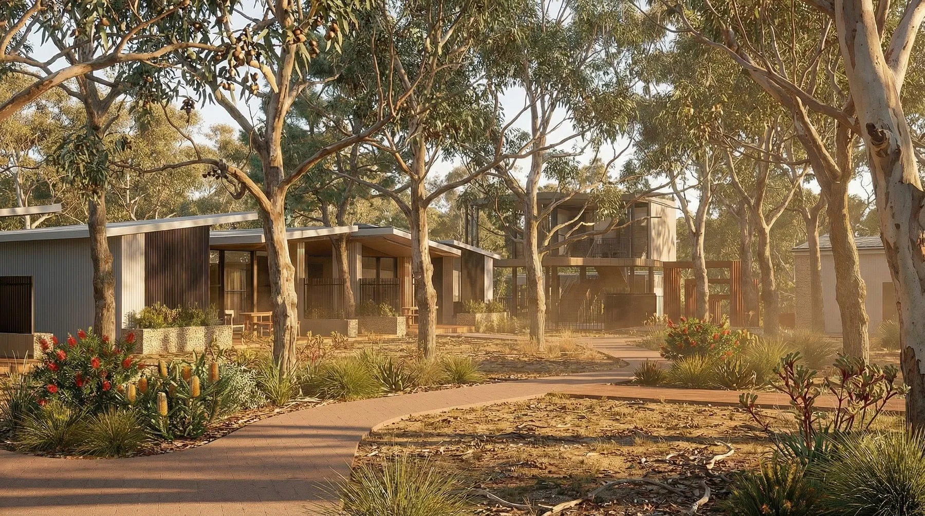 Single-storey residences set among tall gum trees along a winding gravel path